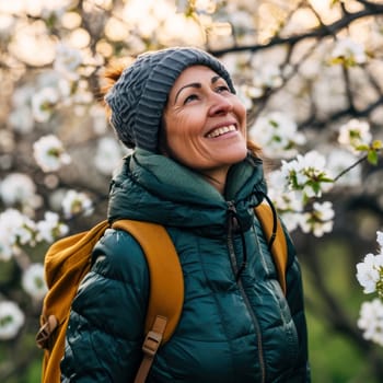 Portrait of a woman in spring with blooming fruit trees