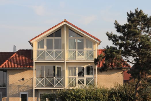 A little beige house with blue sky in the background
