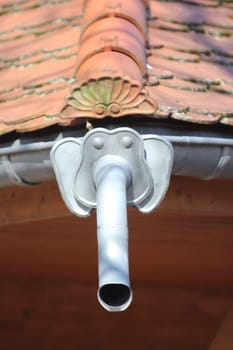Roof drainage pipe in the form of an elephant's head with the trunk as drainage pipe