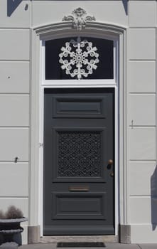 an old, beautifully decorated front door black and white