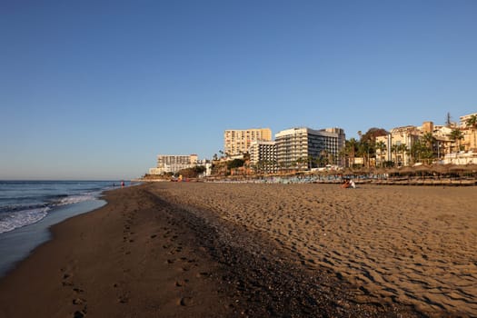 Torremolinos, Spain - September 12, 2023: View of Bajondillo Beach and hotels in Torremolinos at sunrise. Costa del Sol, Spain.