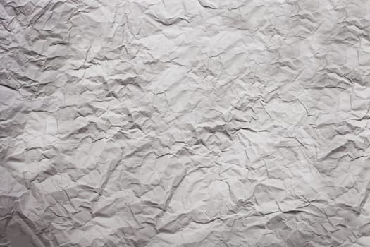 Strongly rumpled paper of gray color. Texture. Background