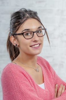 young smiling brunette woman with a pink sweater