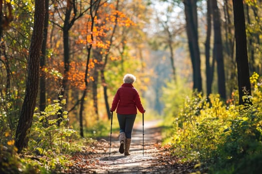 Old woman hiking on a nature path in autumn