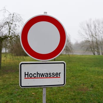 Path closed due to flooding on the banks of the River Elbe in Magdeburg in Germany in January 2024. Translation on the sign: High water