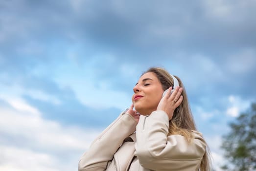 young woman listening music with headphones