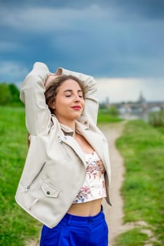young woman with glasses standing on a meadow