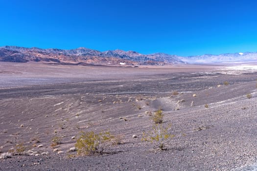 Desolate Plains Distant Mountains in the Desert in Death Valley National Park in California