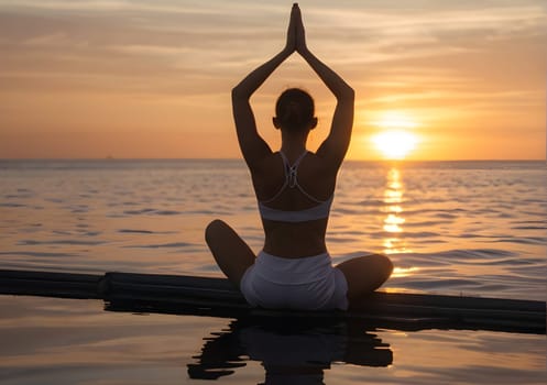Woman naking yoga at the beach