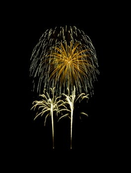 Beautiful Golden fireworks exploding in the night sky, isolated on black background. New year and anniversary concept.