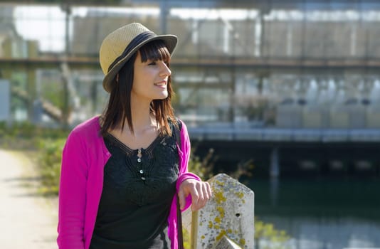 portrait of young brunette girl with summer hat in park, outside