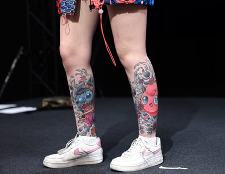 Krakow, Poland - June 11, 2022: Unidentified participant during the contest for the best tattoo at the 15th Tattoofest Convention in Cracow. One of the most prestigious tattoo festivals.