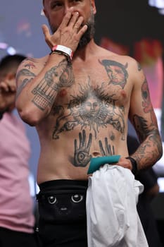 Krakow, Poland - June 11, 2022: Unidentified participant during the contest for the best tattoo at the 15th Tattoofest Convention in Cracow. One of the most prestigious tattoo festivals.