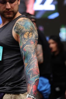 Krakow, Poland - June 12, 2022: Unidentified participant during the contest for the best tattoo at the 15th Tattoofest Convention in Cracow. One of the most prestigious tattoo festivals.