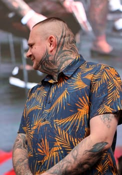 Krakow, Poland - June 12, 2022: Unidentified participant during the contest for the best tattoo at the 15th Tattoofest Convention in Cracow. One of the most prestigious tattoo festivals.