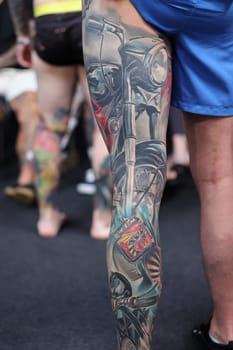 Krakow, Poland - June 12, 2022: Unidentified participant during the contest for the best tattoo at the 15th Tattoofest Convention in Cracow. One of the most prestigious tattoo festivals.