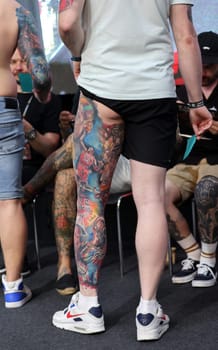 Krakow, Poland - June 12, 2022: Unidentified participant during the contest for the best tattoo at the 15th Tattoofest Convention in Cracow. One of the most prestigious tattoo festivals.