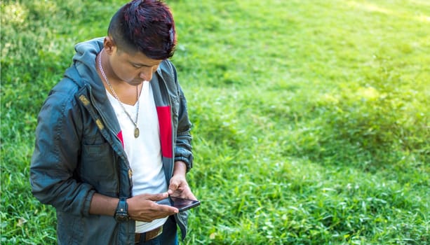 Close up of a man with cell phone in hand, close up of hands with cell phone with white screen, young guy with cell phone in hand with copy space