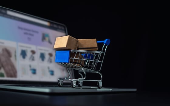 Boxes in a shopping car on a laptop keyboard. Ideas about online shopping, online shopping is a form of electronic commerce that allows consumers to directly buy goods from seller over the internet.