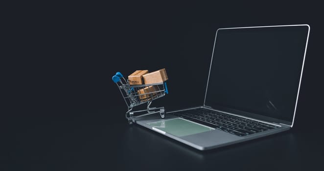 Boxes in a shopping car on a laptop keyboard. Ideas about online shopping, online shopping is a form of electronic commerce that allows consumers to directly buy goods from seller over the internet.