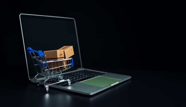 Boxes in a shopping car on a laptop keyboard. Ideas about online shopping, online shopping is a form of electronic commerce that allows consumers to directly buy goods from seller over the internet.