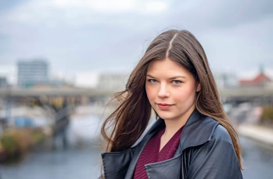 relaxed young woman standing on a bridge