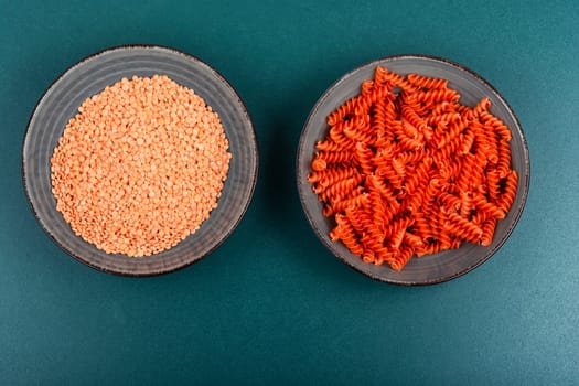 Dry red lentil fusilli pasta. Uncooked vegan pasta. Italy cuisine. Space for text.