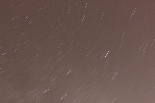 Stars move across the night sky, photographed with long exposure