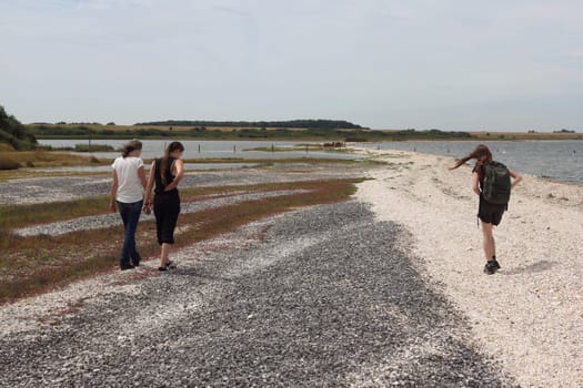 three women walking on the beach at the North Sea coast in the Netherlands