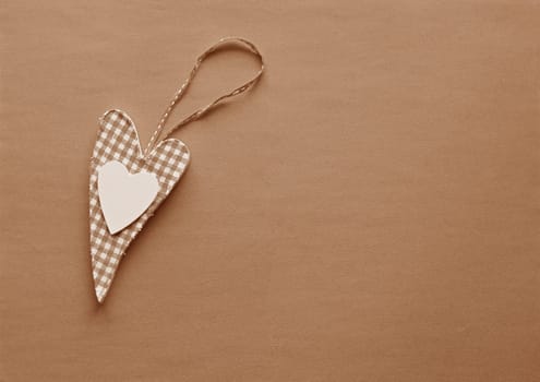 A fabric heart in Peach Fuzz on a paper background