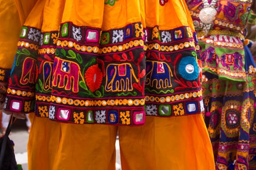 Couple dressed in traditional Indian dress. Mans shirt in the foreground