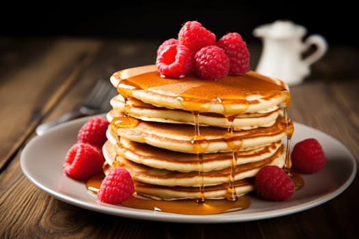 Stack of Pancakes with Maple Syrup and Fresh Raspberries. High quality photo