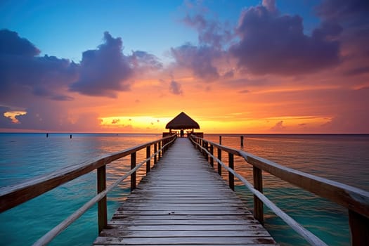 Sunset View from a Wooden Pier Leading to a Thatched Gazebo over the Ocean. High quality photo