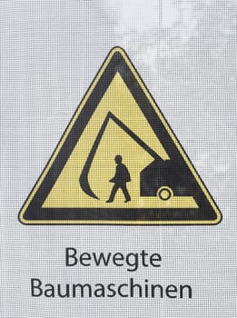 Yellow warning sign for moving construction machinery, Germany