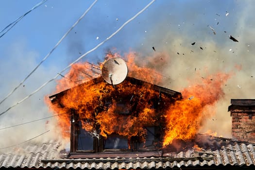 fire on the roof of a wooden house. High quality photo