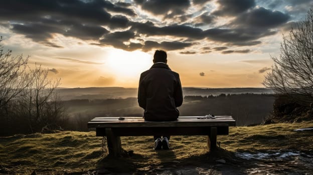 lonely man on a bench looking at the sunset. High quality photo