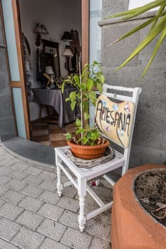 Topfpflanze auf einem weissen Stuhl vor einem Geschäft, Fataga, Gran Canaria, Spanien