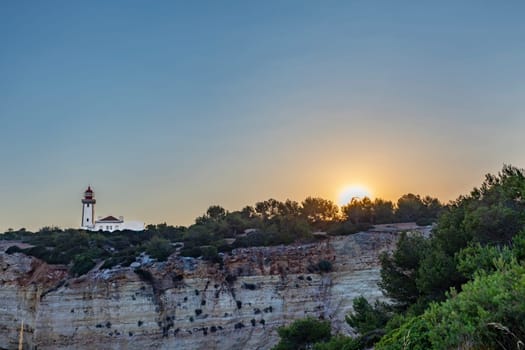 scenic view to lighthouse in Carvoeiro in sunset mood