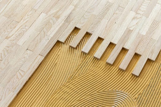 pattern of glue for fixing the parquet at the construction site