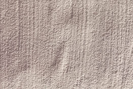old plaster wall textured with lines in light red color