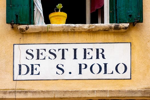 signage sestier de san Polo in Venice  at an old grunge house wall