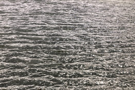 pattern of reflection of sun in waves at the ocean