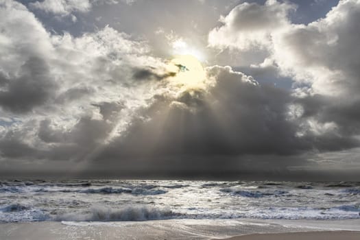 sea landscape with huge waves and sunbeam at the island of Sylt, Germany