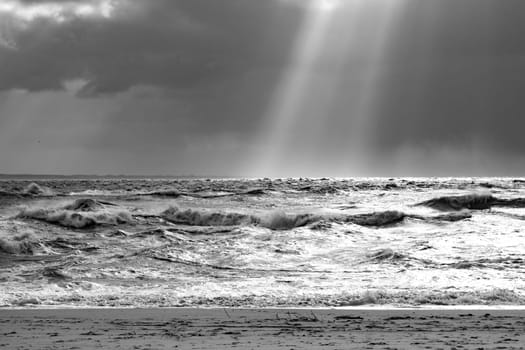 sea landscape with huge waves and sunbeam at the island of Sylt, Germany