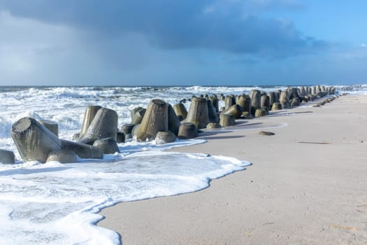 sea landscape with huge waves breaking a poller in Sylt, Germany