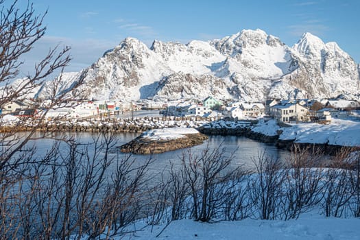 view to Norway village of Henningsvaer,with snow capped mountains