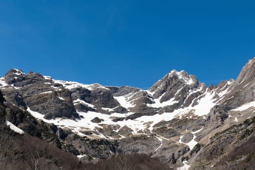 Twin peaks of Punta Felqueral and Pico Pineta in winter seen from the Pineta Valley - Ordesa and Monte Perdido National Park, Spain, Pyrenees