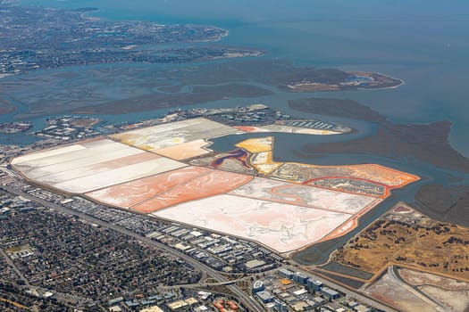 aerial of Newark marshland at the coast with canal and saltern fields to stabilize ground, Newark, San Francisco, USA