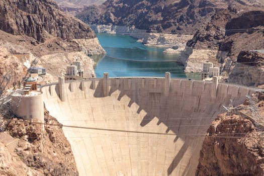 high view of the Hoover Dam in a sunny day between the states of Arizona and Colorado in USA