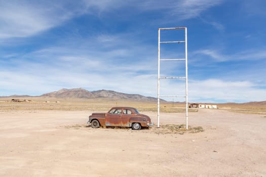 old rotten vintage car at a patrol station in the desert at Route 895 at Rachel, Alamo, Nevada, USA
